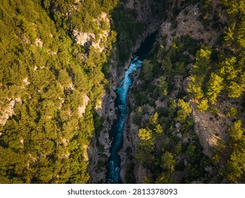 Dramatic aerial view of turquoise river flowing through rocky canyon