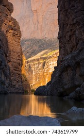 Dramatic, Afternoon In Santa Elena Canyon, Big Band National Park.  Low Angle Sun Reaches The Far End Of The Canyon Turning The Walls Golden While The Canyon In The Foreground Is In Dark Shadow.
