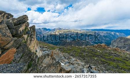 Dramatic Alpine Vista from Beartooth Pass Summit in Montana and Wyoming - a high mountain pass in the Rocky Mountains, it's known for its stunning scenery, glacial lakes, and rugged mountain peaks.