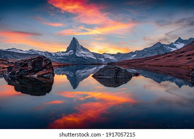 Dramatic Alps scenery. Exciting morning view of Stellisee lake with Matterhorn (Cervino) peak on background. Breathtaking autumn scene of Swiss Alps, Zermatt resort location, Switzerland, Europe.  - Powered by Shutterstock