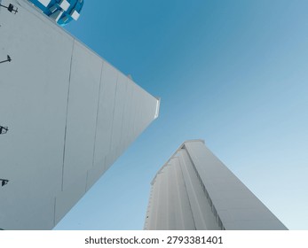 Dramatic architectural perspective of tall modern hotel towers showing immense scale and geometry against the sky in Acapulco, Mexico.