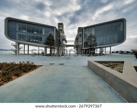 Dramatic Architecture of the Botín Center - A wide-angle, low-view shot of the unique, modern architecture of the Botín Center under a cloudy, dramatic sky.