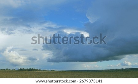 Dramatic and AweInspiring Cloud Formation Over Fields Creating a Stunning Scene in Nature