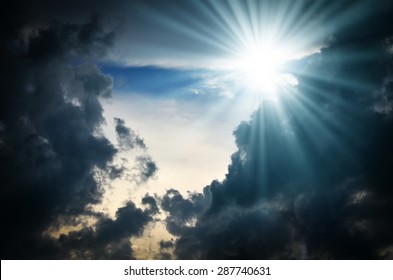 Dramatic backdrop of the blue sky with clouds and sun