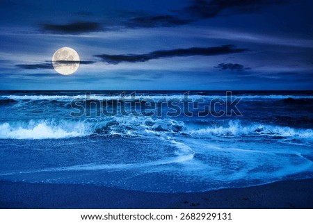 dramatic beach outdoor background at night. scenic coast and sky with clouds. beautiful seascape. wave bring foam on golden sand in full moon light