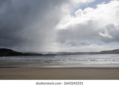 Dramatic Beach Scene with Clouds and Sunlight