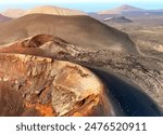 Dramatic beautiful landscape with lava formations, desert, mountains and volcanoes, stunning view of a volcano crater on the island of Lanzarote, Canary Islands.