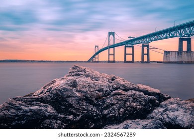 Dramatic beautiful sunset landscape over Claiborne Pell Newport Bridge, a modern tolled suspension bridge across Narragansett Bay, connecting Newport  Jamestown, Rhode Island