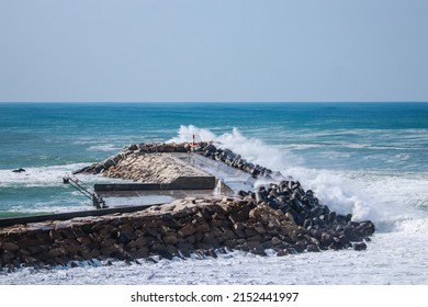 A Dramatic Big Sea Waves Splashing On Stone Breakers During A Stormy Day