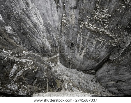 Dramatic bird's-eye view looking down into the deep, snowy limestone canyon of Enshi Grand Canyon, Hubei, China.
