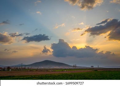 Dramatic black and red clouds with sunbeam over adacal hill at sunset, Emirdag, Afyonkarahisar, Turkey