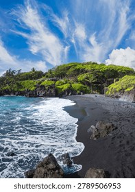 Dramatic Black Sand Beach with Volcanic Rocks and Lush Green Cliffs Under Wispy Cirrus Clouds, Maui, Hawaii, USA
