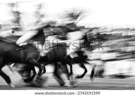 Dramatic black and white abstract motion blur of a cavalry charge, capturing the intense energy and chaotic speed of horses and riders in a fast-paced outdoor historical reenactment.