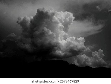 Dramatic Black and White Cloud Formation with Mountain Silhouette