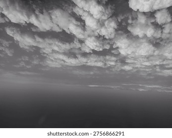 Dramatic Black and White Cloudscape over a Dark Horizon
