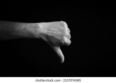 Dramatic Black And White Image Of Thumbs Down Emoji Isolated On Black Background