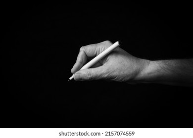 Dramatic Black And White Image Of Writing Hand Emoji Isolated On Black Background