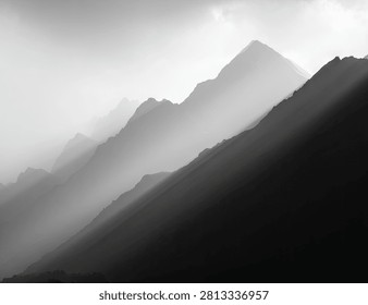 A dramatic black and white landscape featuring layers of misty mountain silhouettes fading into the distance with soft atmospheric light.