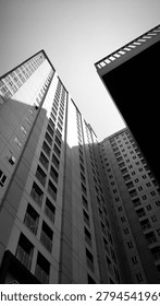 Dramatic black and white low angle view of a dense residential high-rise building complex