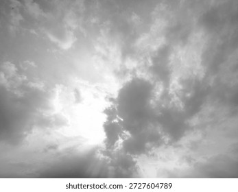 Dramatic Black and White Sky with Sun Rays Piercing Through Dark Clouds, Monochrome Cloudscape Atmosphere, Moody Natural Light Texture for Background and Graphic Design Overlay