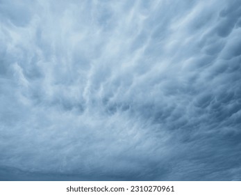 Dramatic blue sky with clouds. Spooky abstract background pattern texture. Horror, Halloween, evil, armagedon, apocalypse concept.