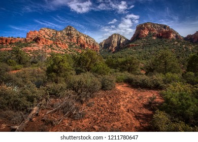 Dramatic blue sky and cloudscape over Capitol Butte (aka Thunder Mountain) from Vultee Arch hiking trail, Sedona, Arizona