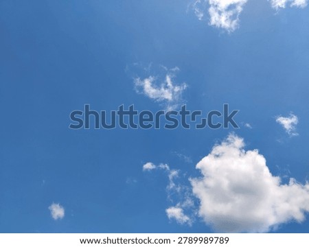 dramatic blue sky filled with bright white cumulus clouds on a sunny day. Natural cloud formations create a peaceful atmospheric scene, ideal for weather, climate, nature, environment, travel, seasonal, and outdoor-themed visual projects.