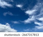 Dramatic blue sky filled with white and golden clouds, creating a dynamic and vast natural background.