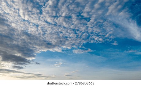 Dramatic blue sky with white altocumulus cloud pattern covering the sky in West Sumatra, Indonesia