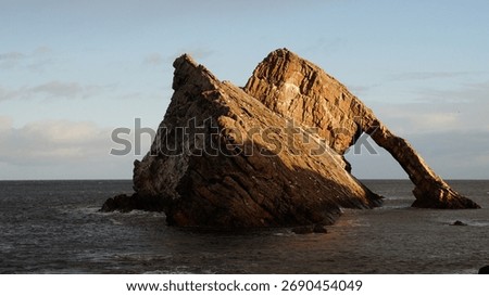 Dramatic Bow Fiddle Rock in a warm sunlight, Portknockie, Scotland. 