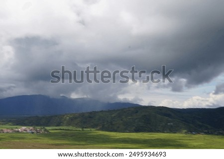 A dramatic capture of dark, looming rain clouds gathering in the sky, signaling an impending downpour. The photo vividly depicts the contrast between the ominous clouds 
