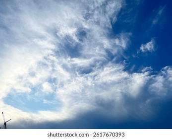 A dramatic capture of swirling clouds just before sunset, with hints of turquoise and deep blue creating a striking contrast. The dynamic patterns in the sky seem almost alive—an unfiltered moment of 