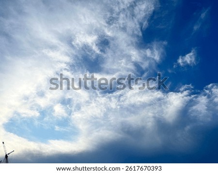 A dramatic capture of swirling clouds just before sunset, with hints of turquoise and deep blue creating a striking contrast. The dynamic patterns in the sky seem almost alive—an unfiltered moment of 