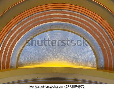 Dramatic ceiling fresco-type artwork and sky painting, with gilded edges and sweeping architecture, in a train station from its glory days, share artistic care and meticulous work high above the floor capturing grandeur of the human spirit and artistic pursuits. Great for backgrounds, room for text, textures, backdrops.- A large half-circle shape dominates the image.
Multiple concentric orange and white bands or ribs arch over the top.
The center section is a bluish-gray textured surface, possibly metal, frosted glass, or painted material.
A warm yellow light glows along the bottom edge of the semicircle, creating a backlit effect.
The overall appearance resembles:
An illuminated archway or alcove,
The inside of a decorative dome,
A retro-futuristic ceiling feature,
Or a stylized architectural element in a building or transportation hub.
The image is cropped tightly enough that it's difficult to determine the exact object or location, but it gives a strong impression of curved architectural design with integrated lighting and layered arches.
