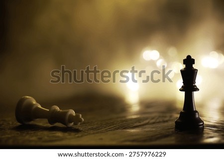 Dramatic Chess Scene with King and Fallen Pieces on Wooden Board in Low Light