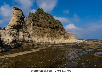 Dramatic cliff formations at Klayar Beach in Pacitan, East Java, Indonesia, overlooking the ocean
