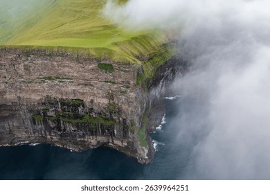 Dramatic Cliff Overlooking the Ocean on Faroe Islands - Aerial View - Powered by Shutterstock - Get 15% off with code: PIKWIZARD15