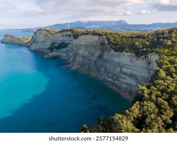 Dramatic cliffs meet turquoise waters in a stunning coastal landscape.