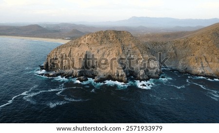 Dramatic cliffs and ocean waves at Punta Lobos, Baja California.