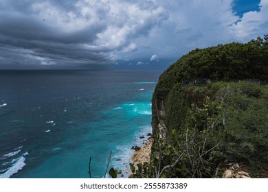 Dramatic cliffs overlooking a turquoise ocean under a stormy sky. Scenic coastal landscape. - Powered by Shutterstock