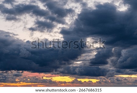 Dramatic clody evening sky with colored sunset line