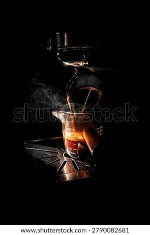 A dramatic close-up of freshly brewed espresso flowing from an espresso machine into a glass measuring cup. Warm light highlights the rich coffee stream and rising steam against a dark background, creating a moody and cinematic atmosphere. The image captures the artistry of coffee preparation, emphasizing warmth, aroma, and craftsmanship.