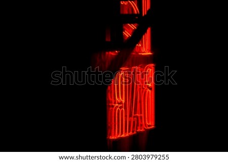 Dramatic close-up of glowing red neon sign spelling DAVID against deep black night background. Moody and cinematic lighting perfect for urban night vibes