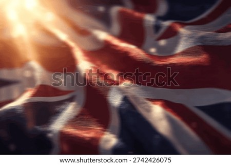 A dramatic close-up of the Union Jack flag, with golden sunlight breaking through, creating a patriotic and inspiring atmosphere.
