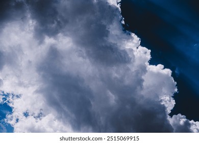 Dramatic cloud formation in dark sky
Large, billowing clouds dominate the sky, with patches of dark blue in the background, creating a moody and dramatic atmosphere.
