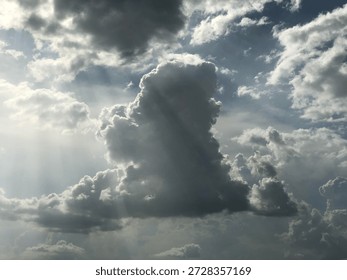 Dramatic cloud formation with sunlight rays in sky