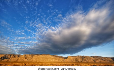 Dramatic Cloud Overshadows The Stark Desert Landscape