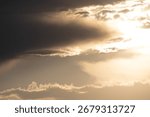 Dramatic clouds create a captivating sky display during sunset at a serene landscape