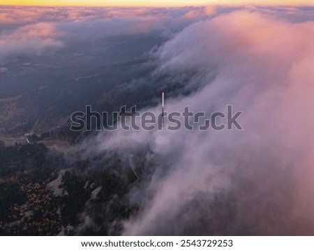 Dramatic clouds enveloping a mountain in monochrome