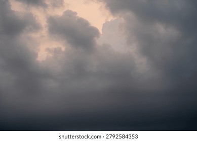 Dramatic clouds gather in a moody sky as daylight fades.